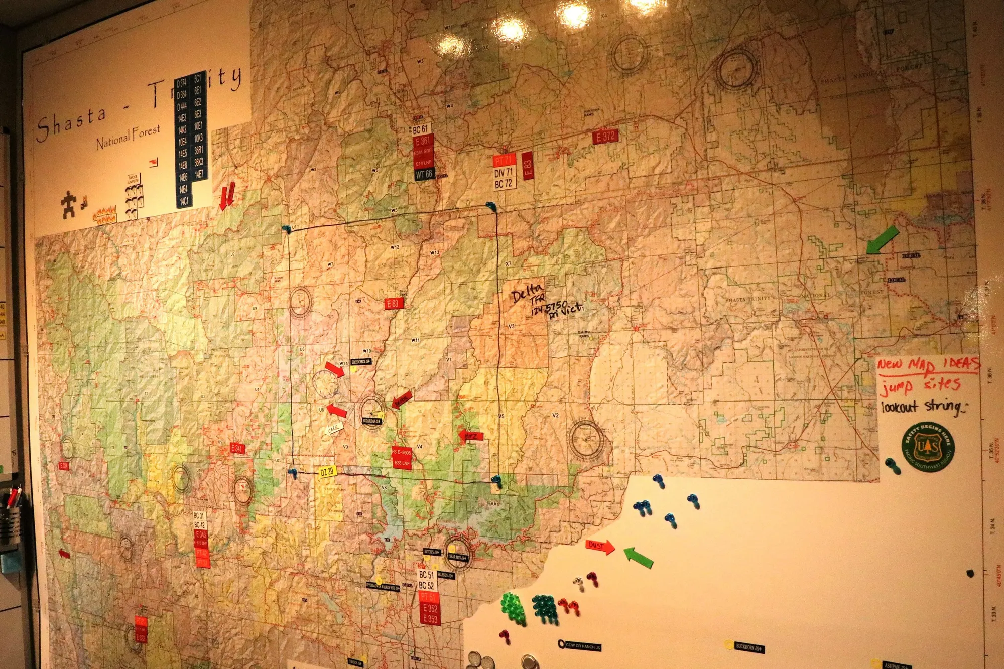 A county wall map in an emergency dispatch center, marked with pins