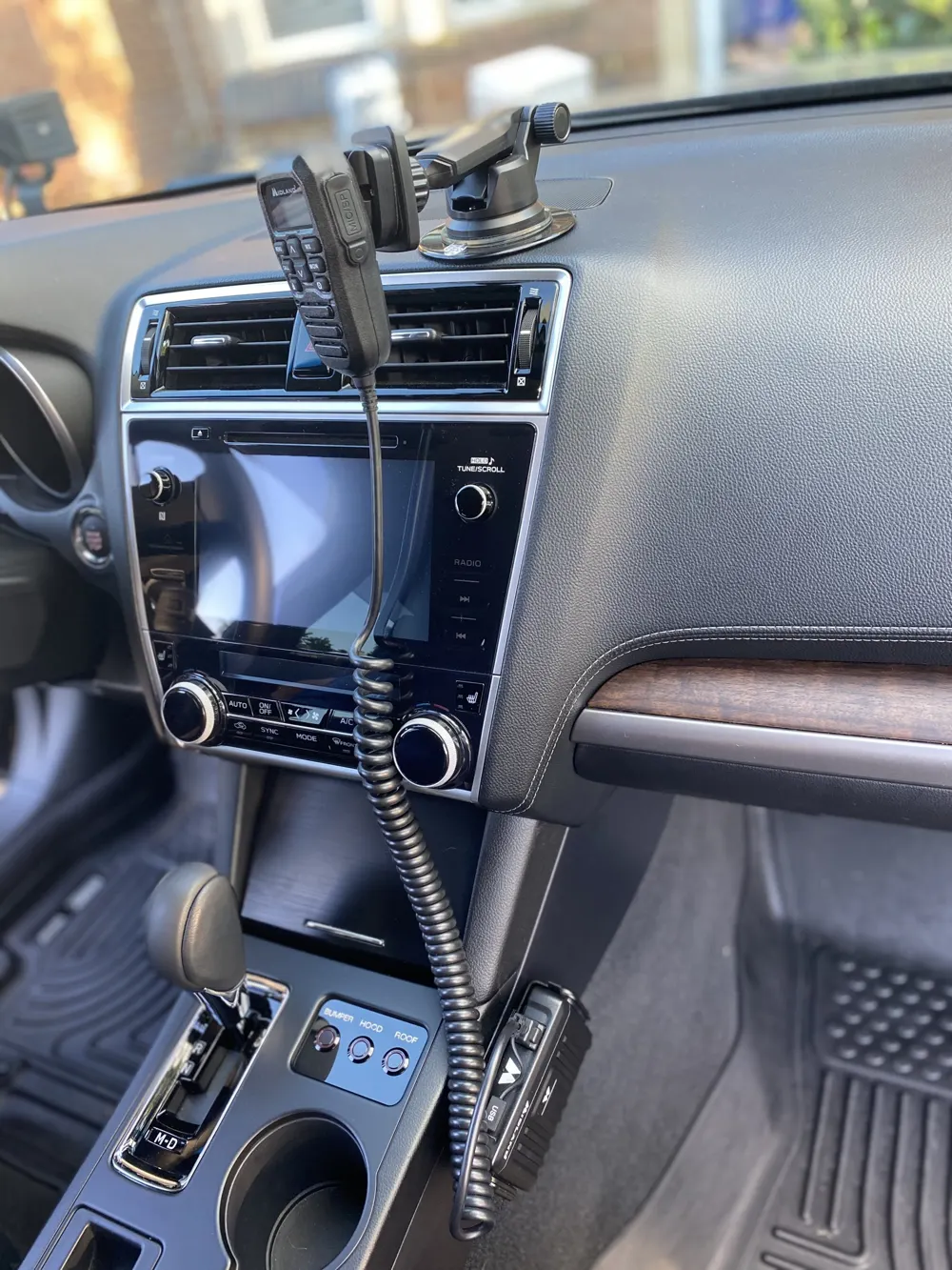 A Midland GMRS car radio microphone mounted on a dashboard
