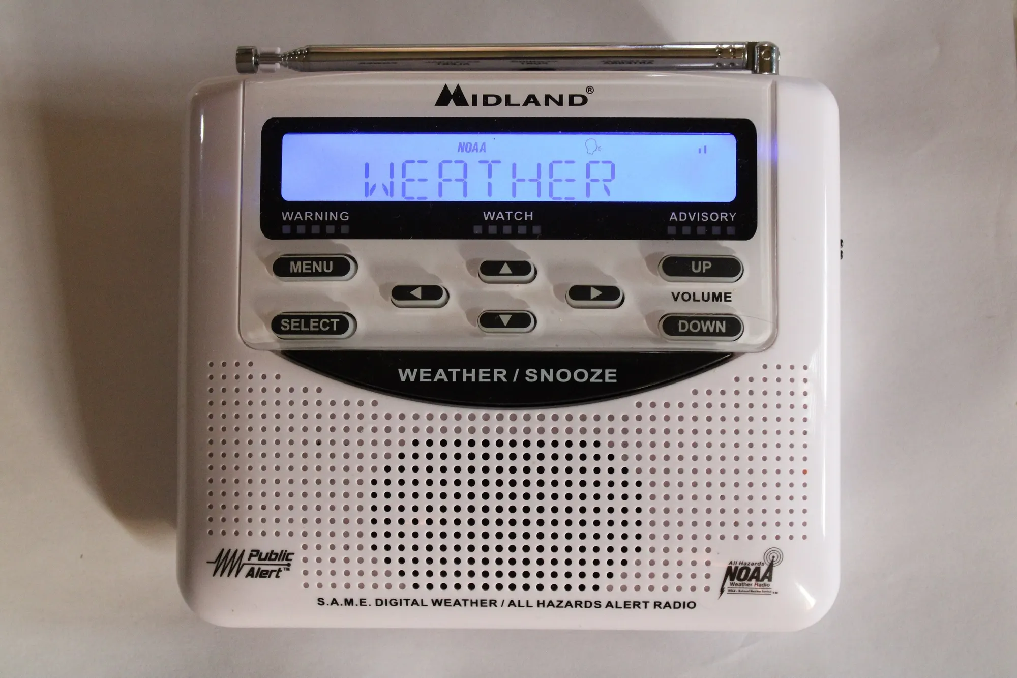 A white Midland weather alert radio showing the word WEATHER on its screen